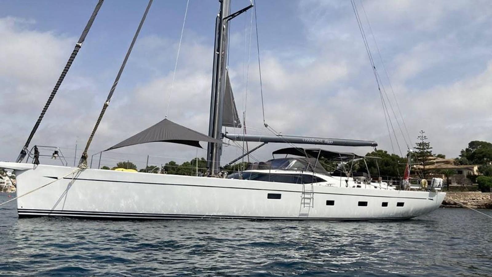 a white boat on the water aboard CHAMPAGNE HIPPY Yacht for Sale