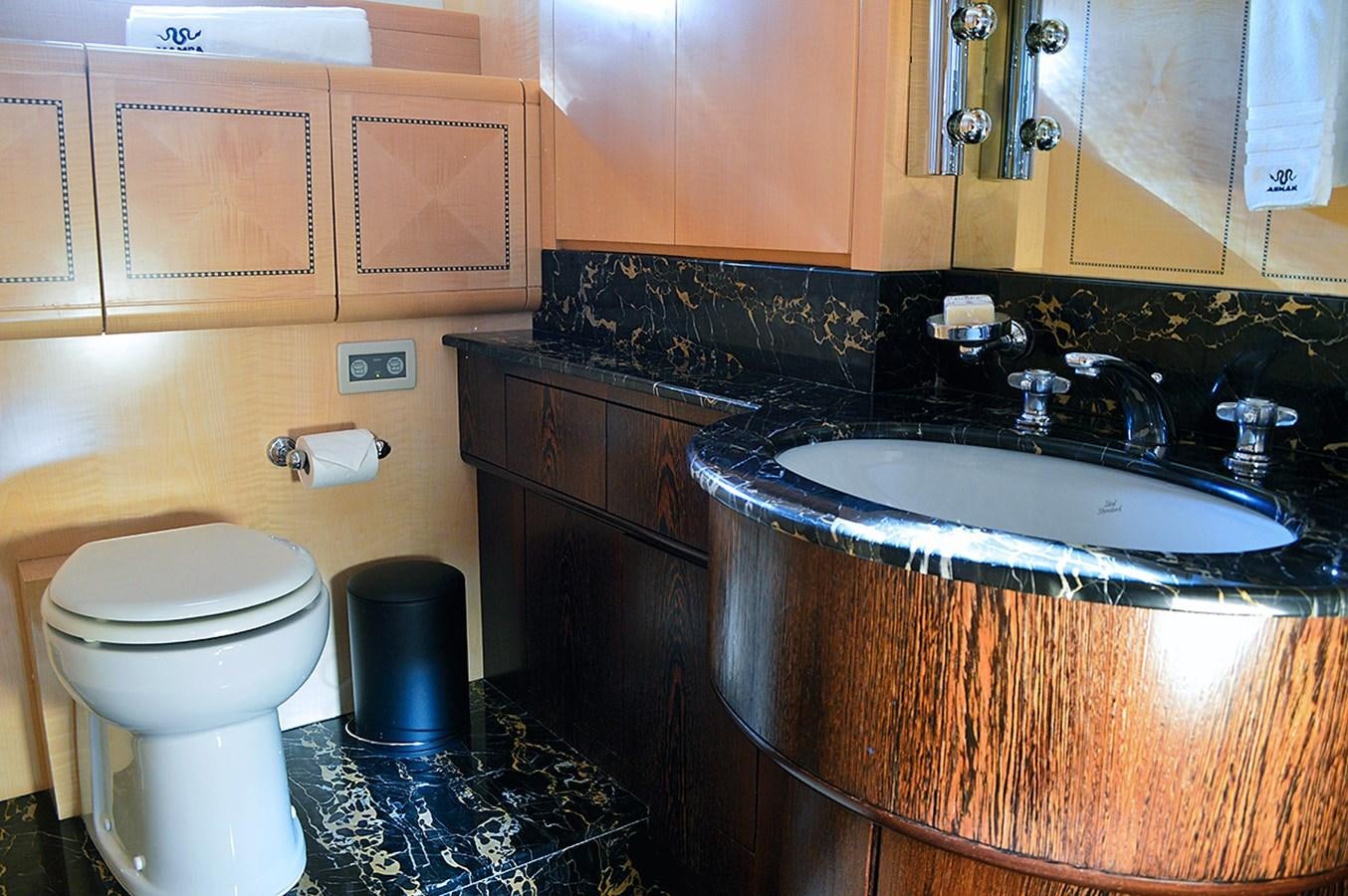 a bathroom with a toilet sink and cabinets aboard MAMBA Yacht for Sale