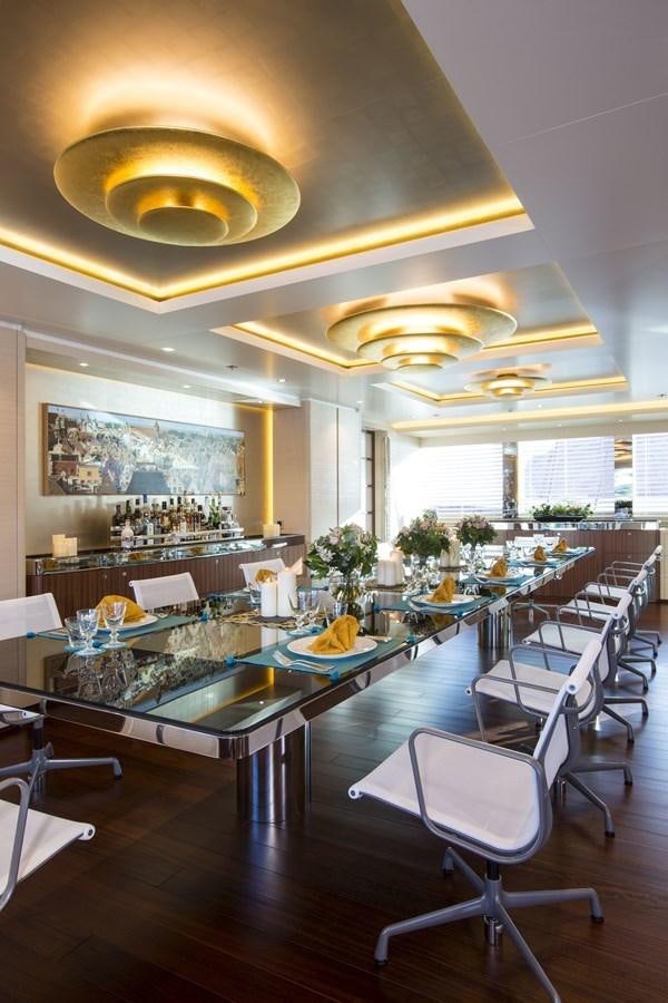 a large room with a table and chairs aboard AQUIJO Yacht for Sale