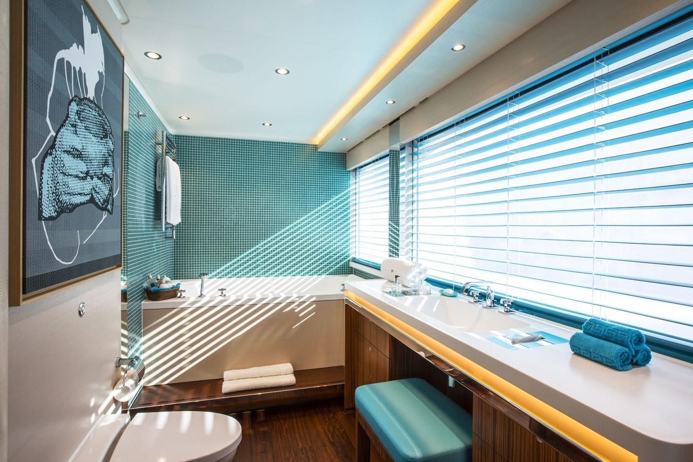 a bathroom with a tub sink and a mirror aboard AQUIJO Yacht for Sale