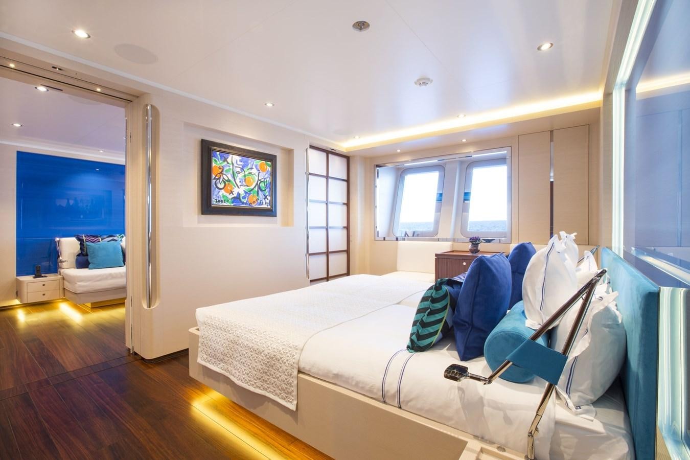 a bedroom with a bed and a window aboard AQUIJO Yacht for Sale