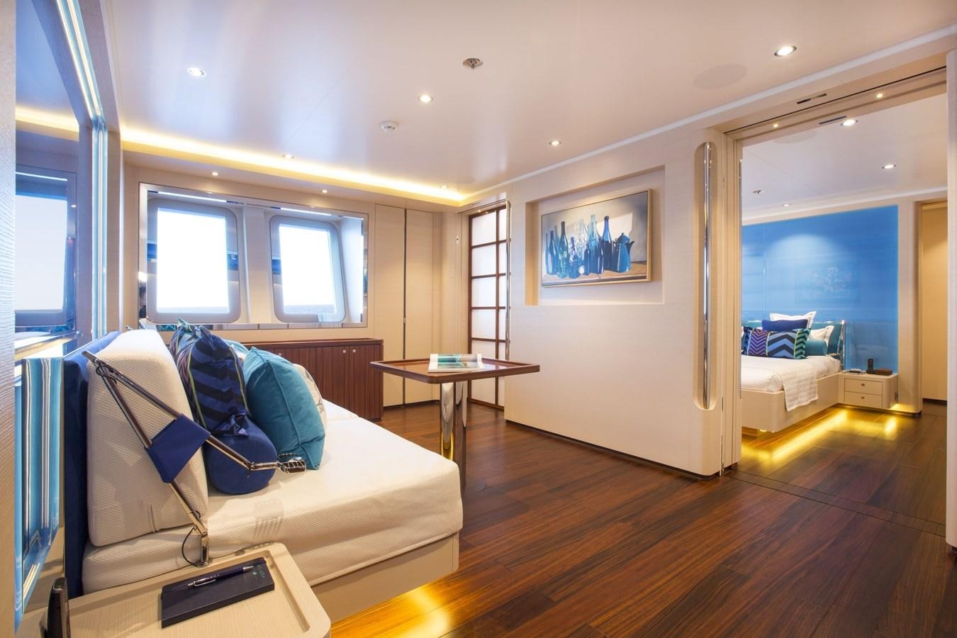 a living room with a couch and a table aboard AQUIJO Yacht for Sale