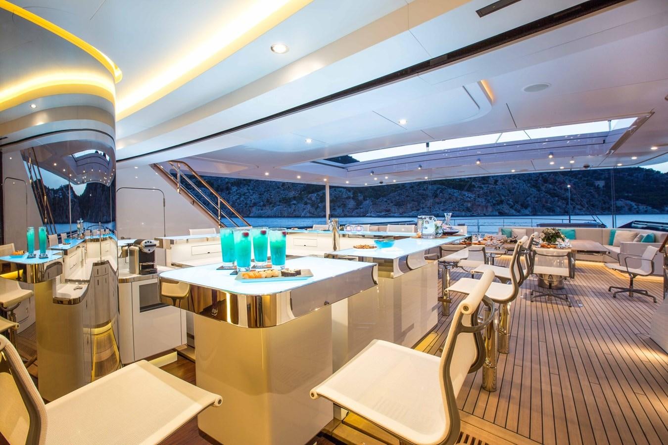 a room with tables and chairs aboard AQUIJO Yacht for Sale