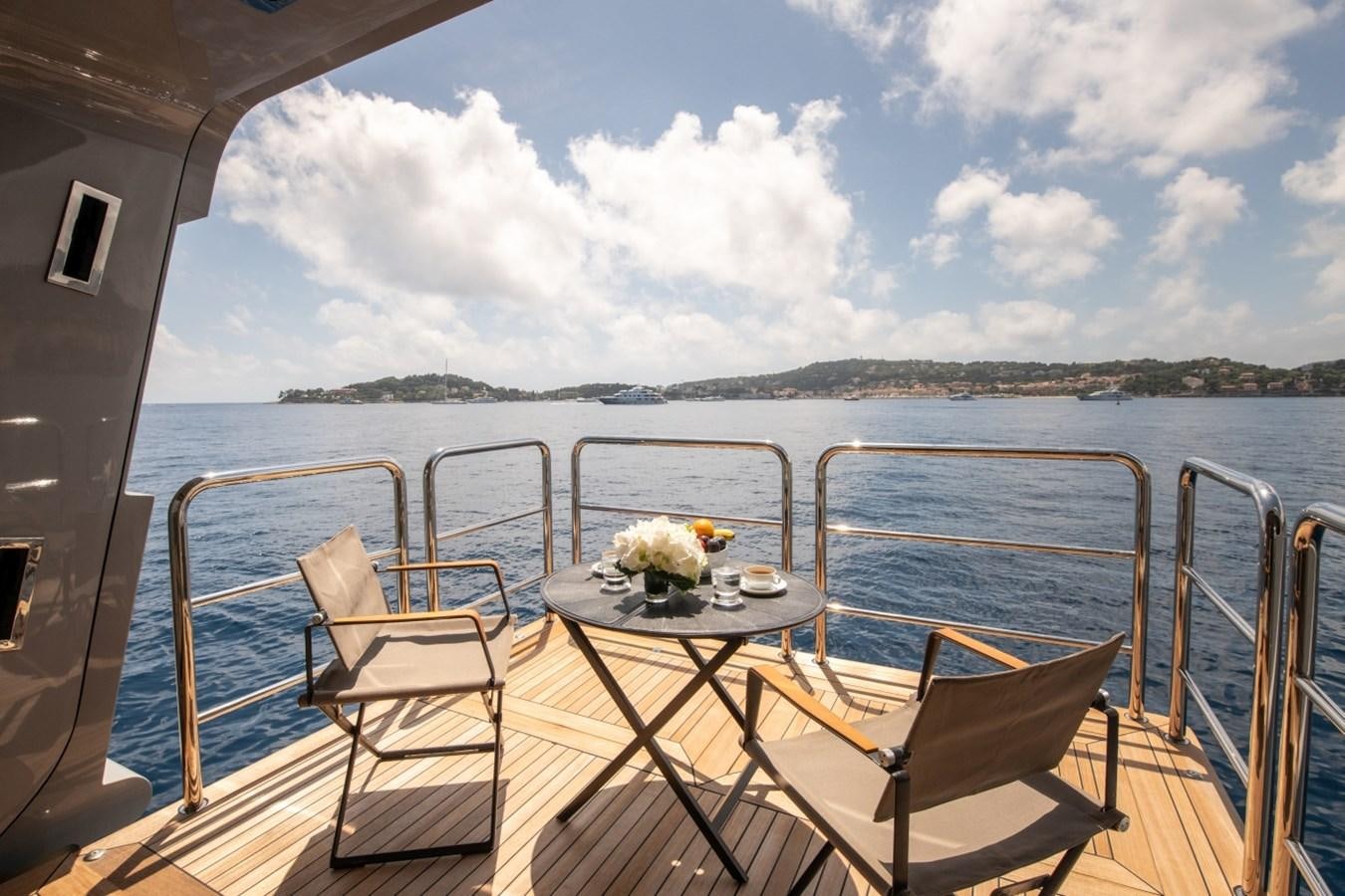 a boat with a table and chairs on the deck aboard ARBEMA Yacht for Charter