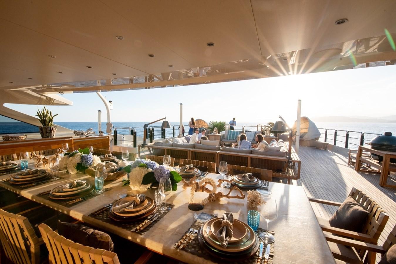 a dining room table with a large table set for a party aboard ARBEMA Yacht for Charter