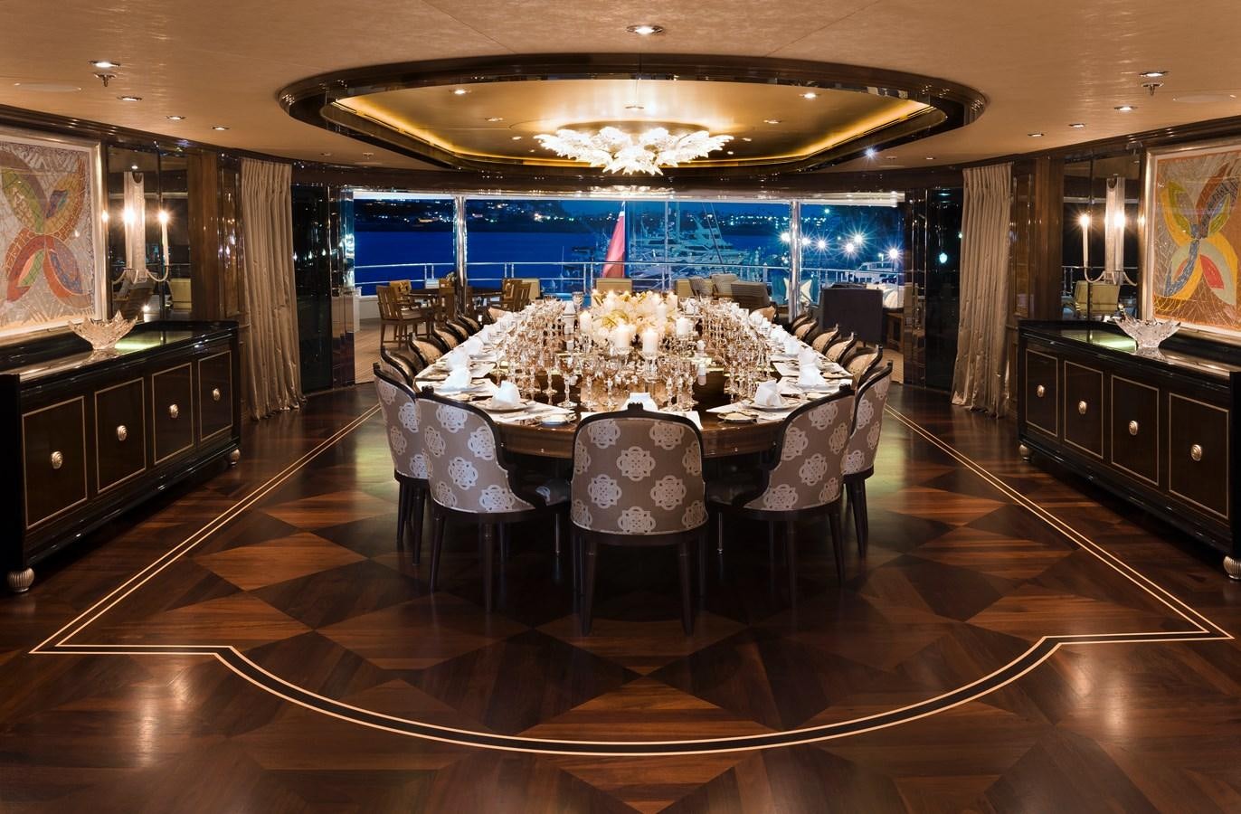 a large room with a table and chairs aboard INVICTUS Yacht for Sale
