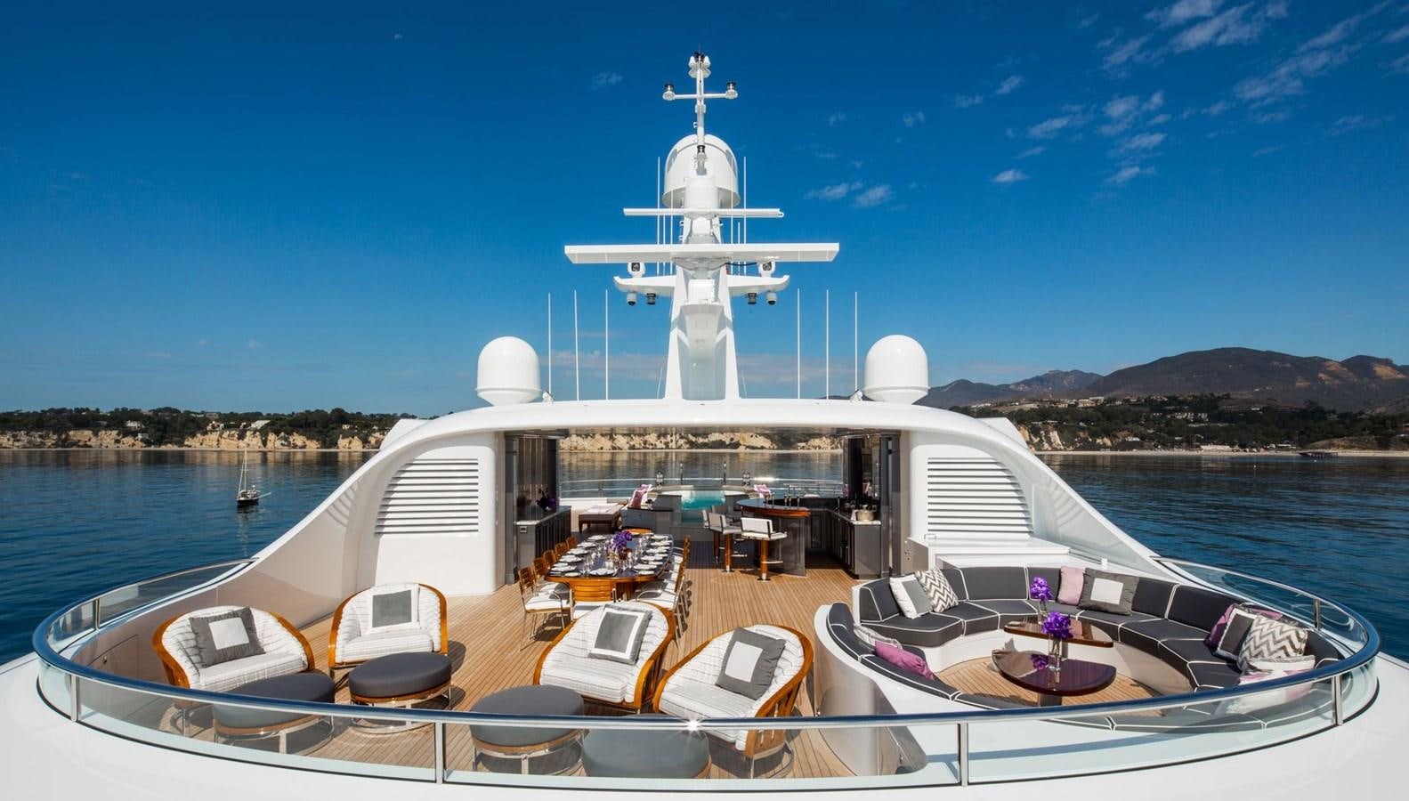 a large white ship docked at a pier aboard INVICTUS Yacht for Sale