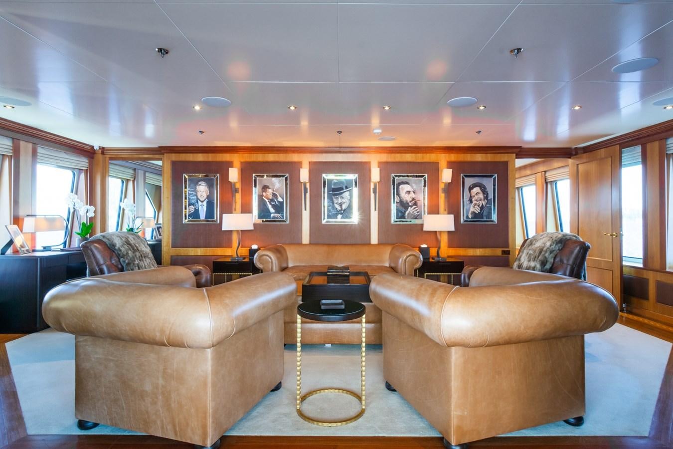 a living room with leather couches aboard THE WELLESLEY Yacht for Sale