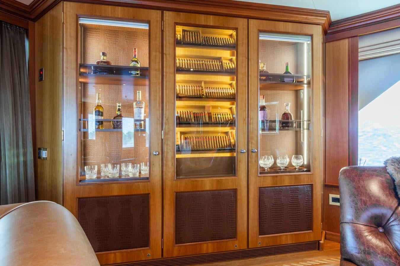 a cabinet with shelves and bottles aboard THE WELLESLEY Yacht for Sale