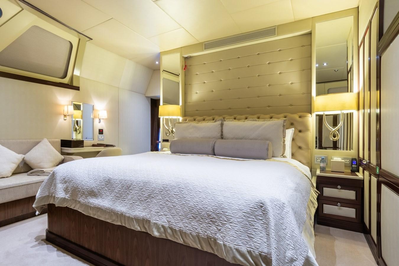 a room with a bed and a mirror aboard THE WELLESLEY Yacht for Sale