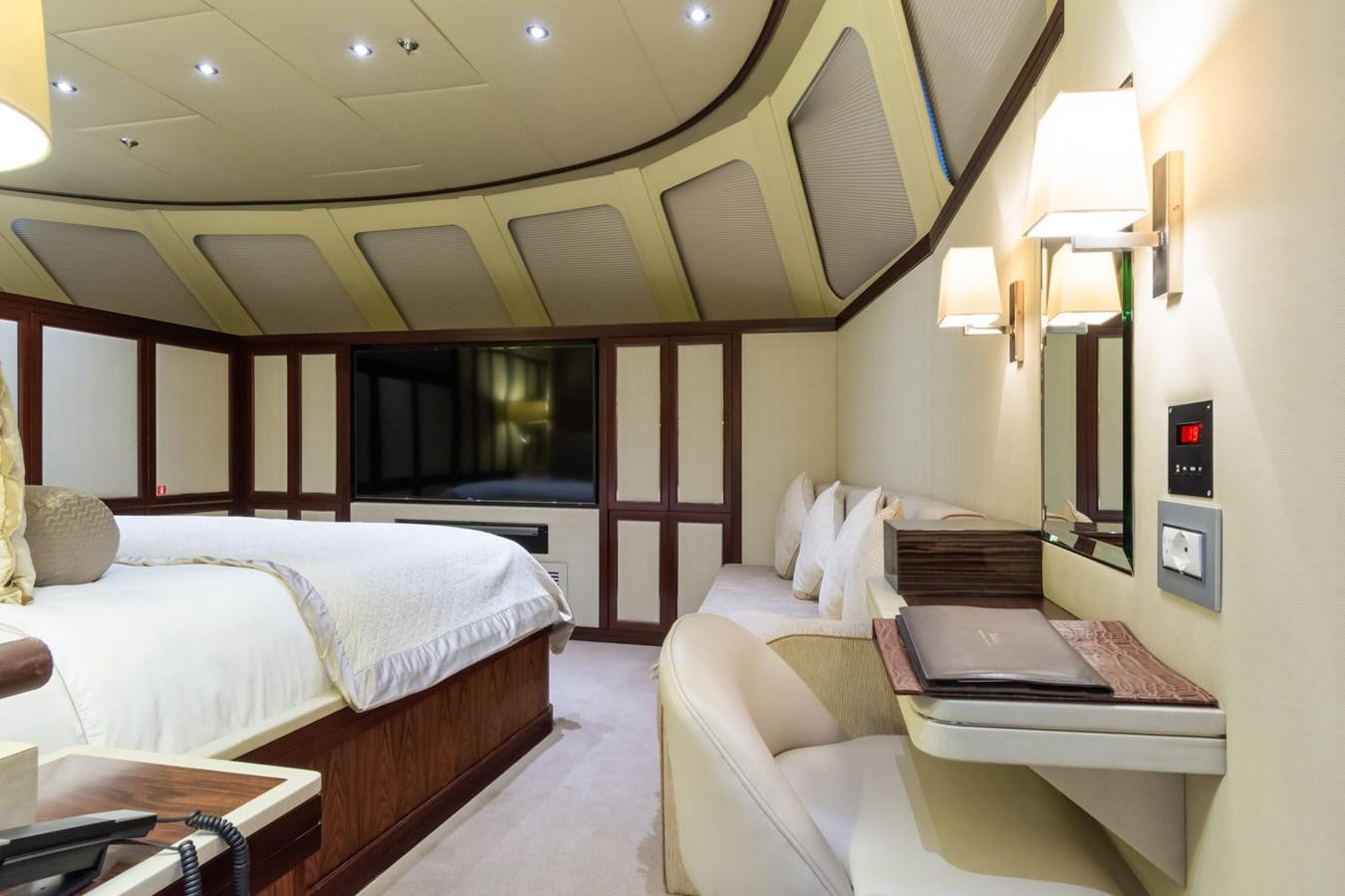 a room with a bed and desk aboard THE WELLESLEY Yacht for Sale