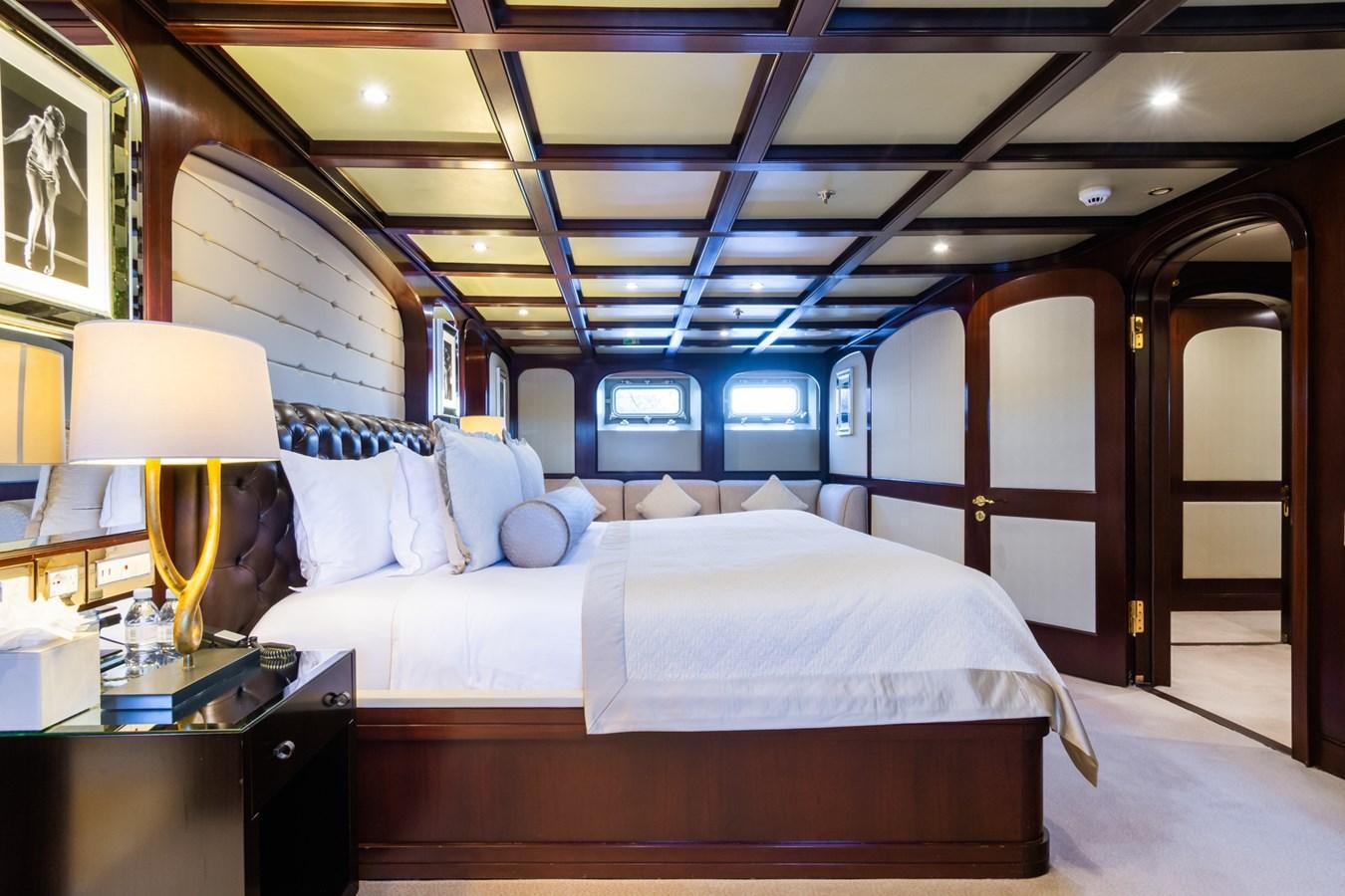 a room with a bed and a lamp aboard THE WELLESLEY Yacht for Sale