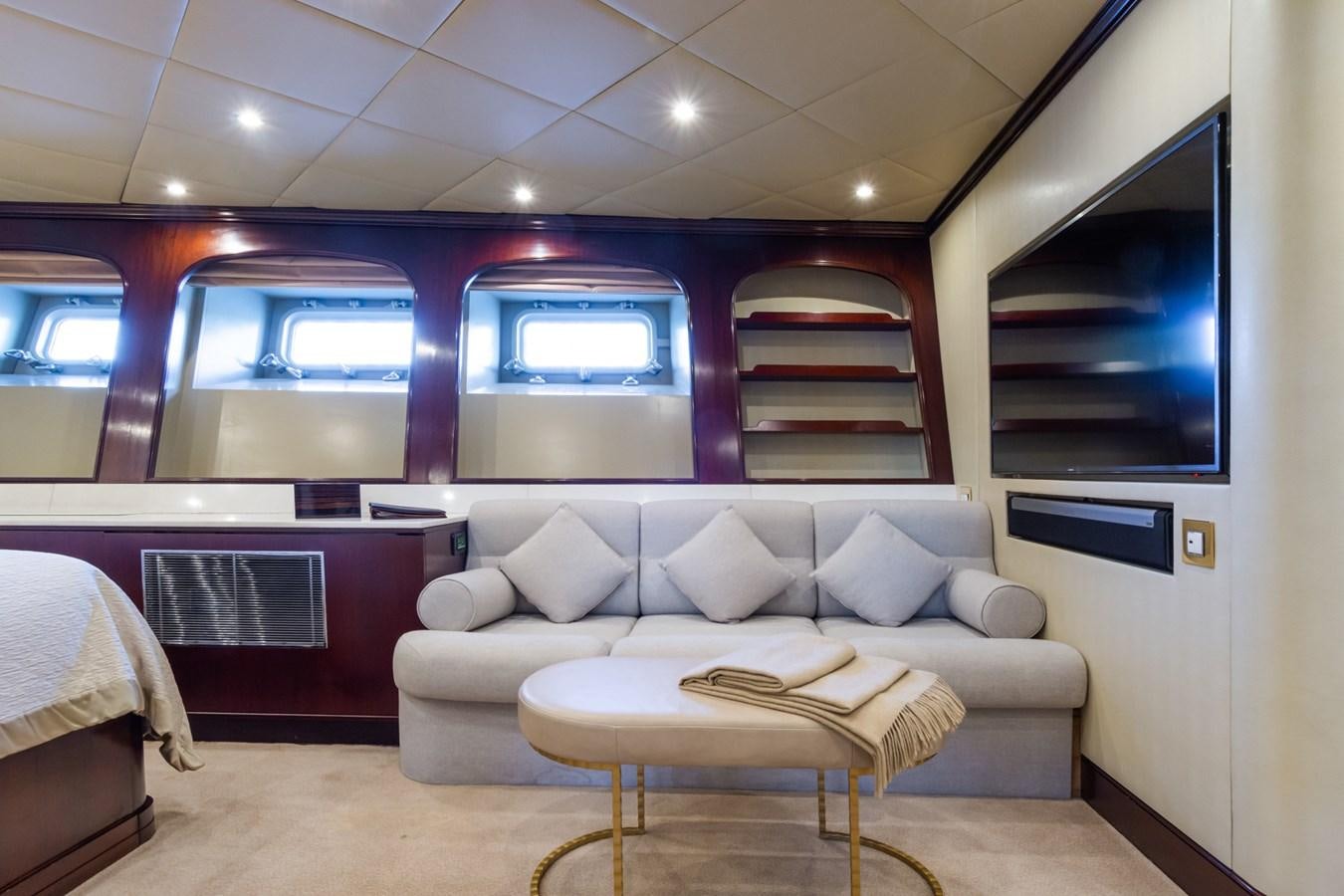 a room with a couch and a tv aboard THE WELLESLEY Yacht for Sale