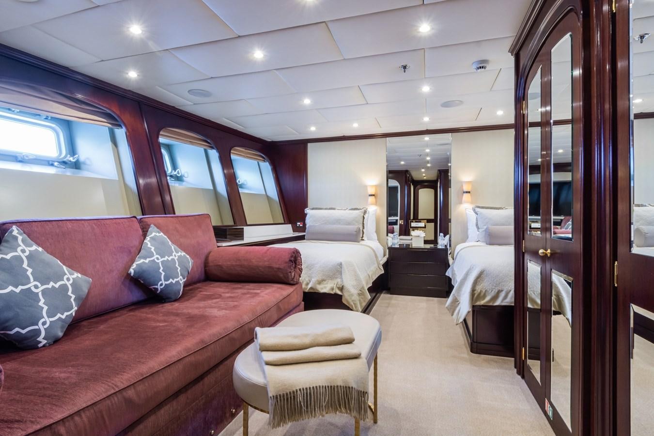 a room with a bed and a couch aboard THE WELLESLEY Yacht for Sale