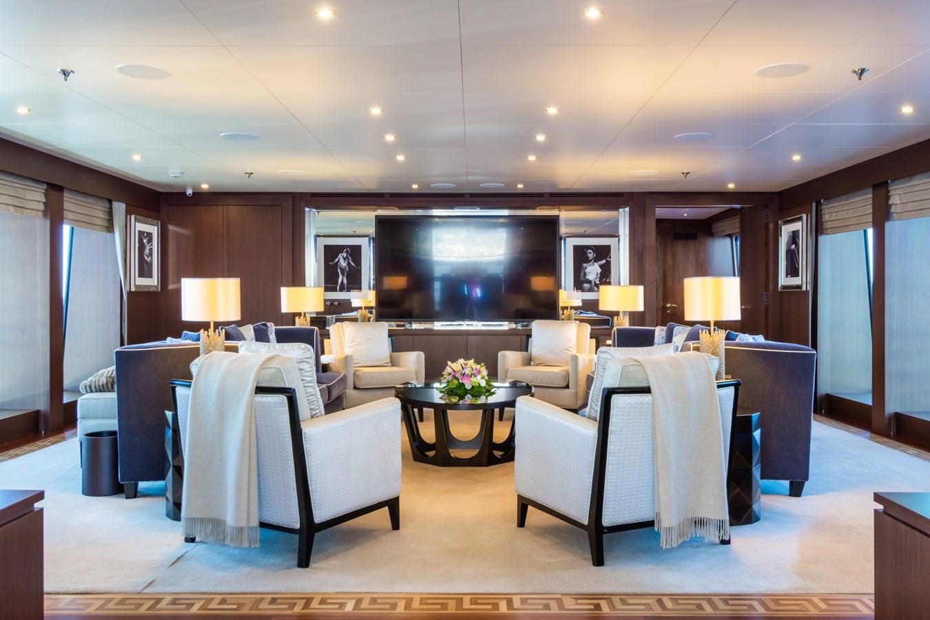 a large living room with a large screen aboard THE WELLESLEY Yacht for Sale
