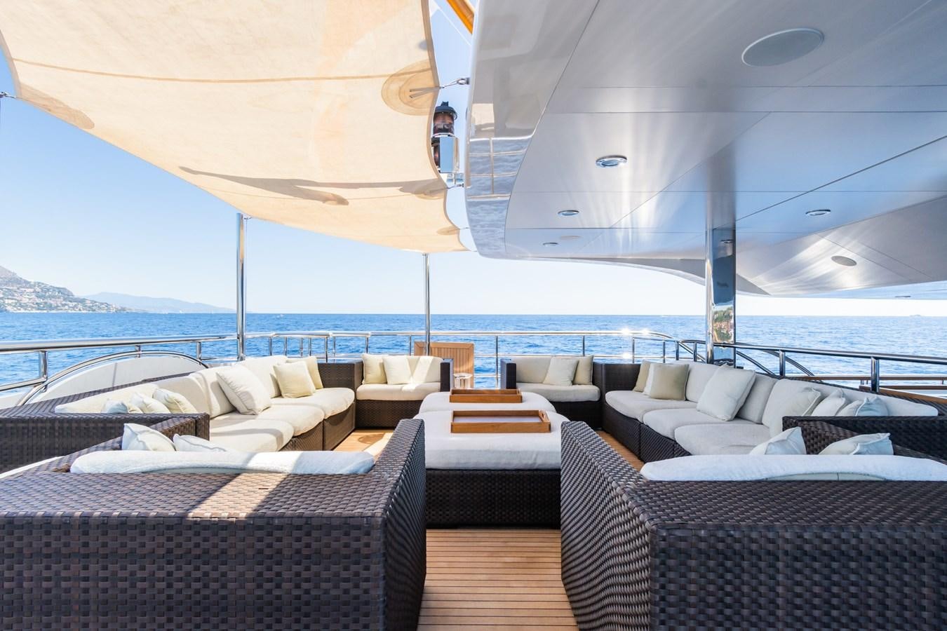a boat with a table and chairs on a deck aboard THE WELLESLEY Yacht for Sale