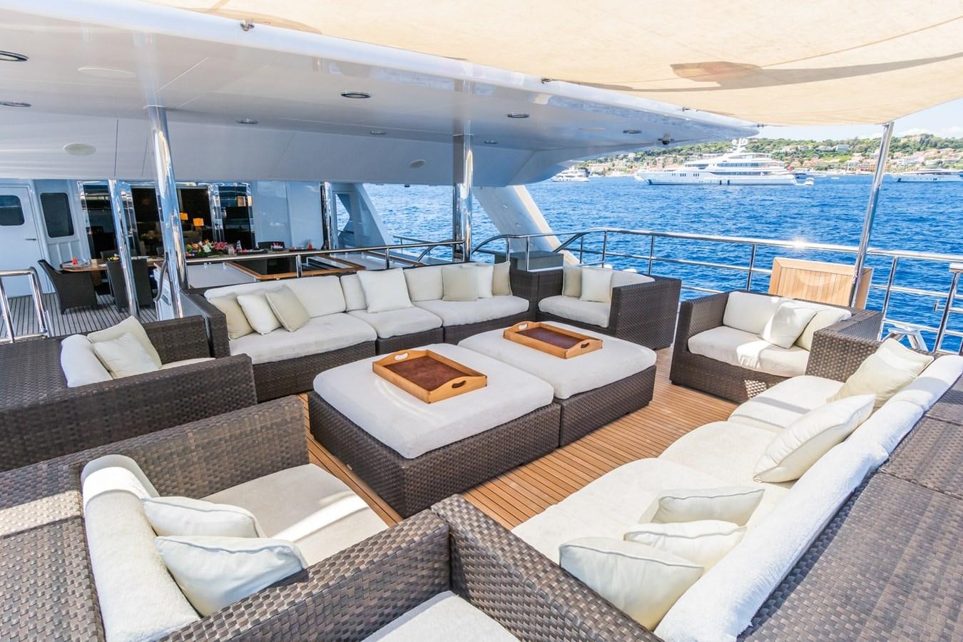 a living room with a large cruise ship in the background aboard THE WELLESLEY Yacht for Sale