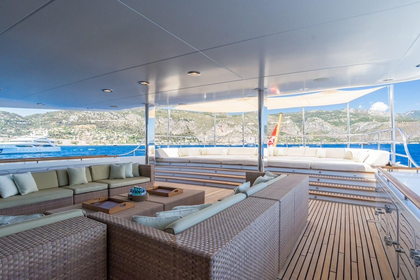 a deck with a view of a body of water and a large ship aboard THE WELLESLEY Yacht for Sale
