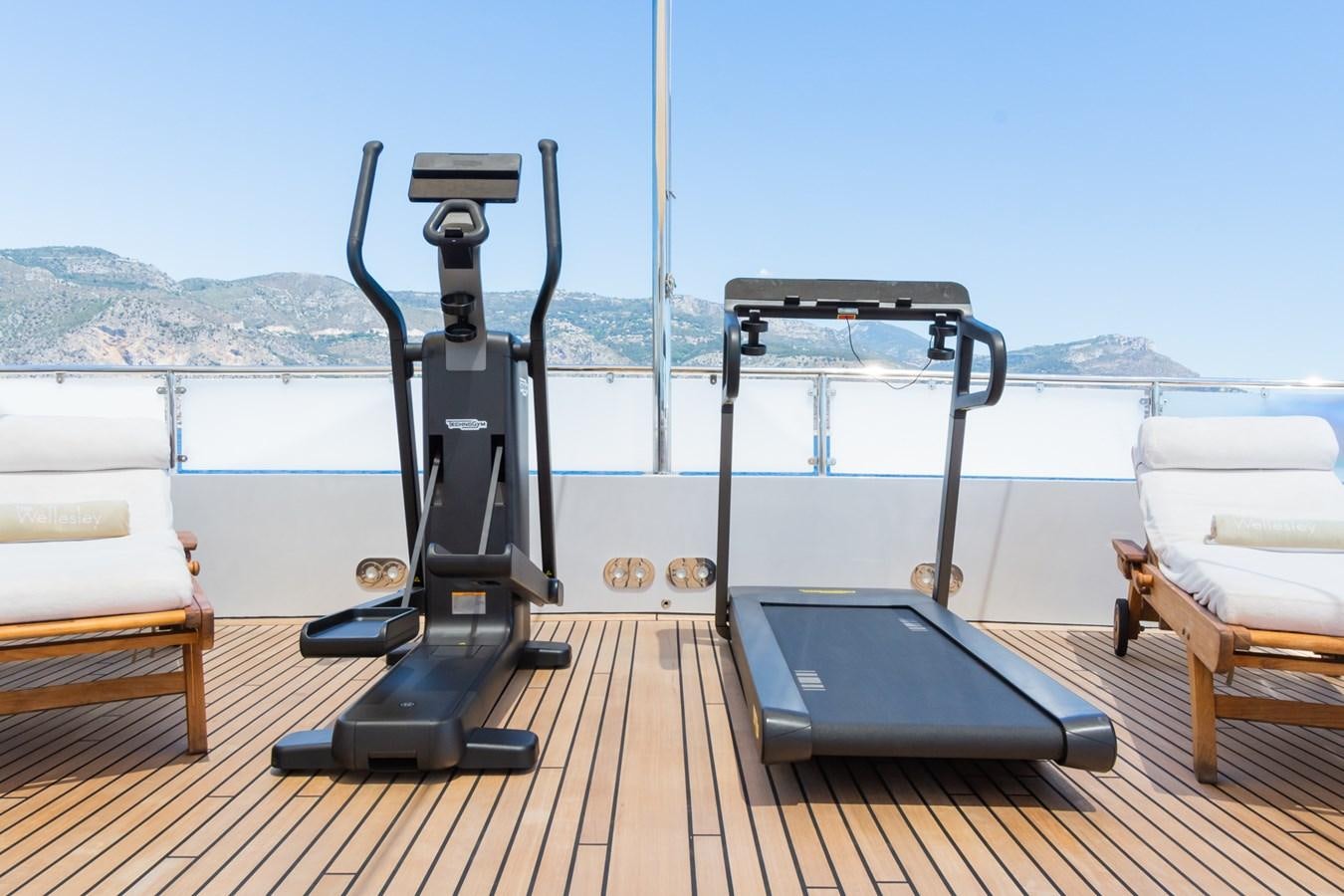 a deck with a laptop and a camera on it aboard THE WELLESLEY Yacht for Sale
