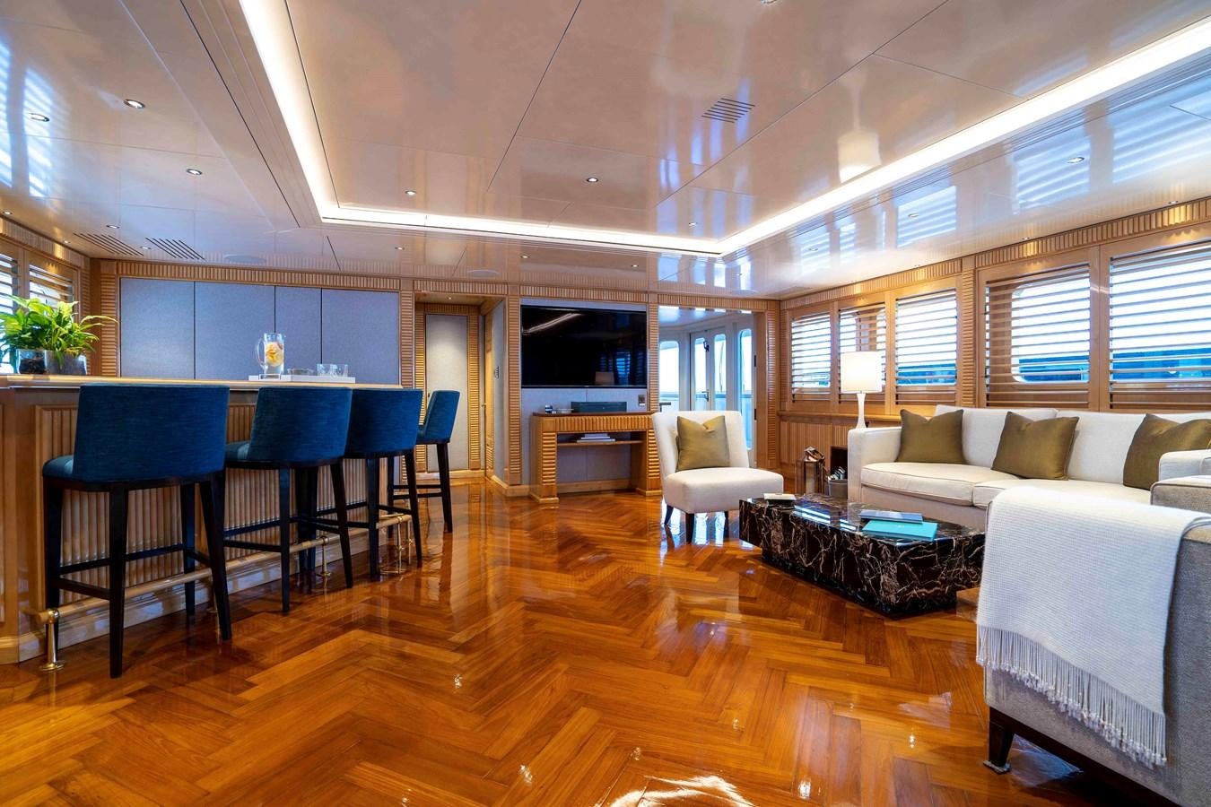 a living room with a wood floor aboard TACANUYA Yacht for Sale