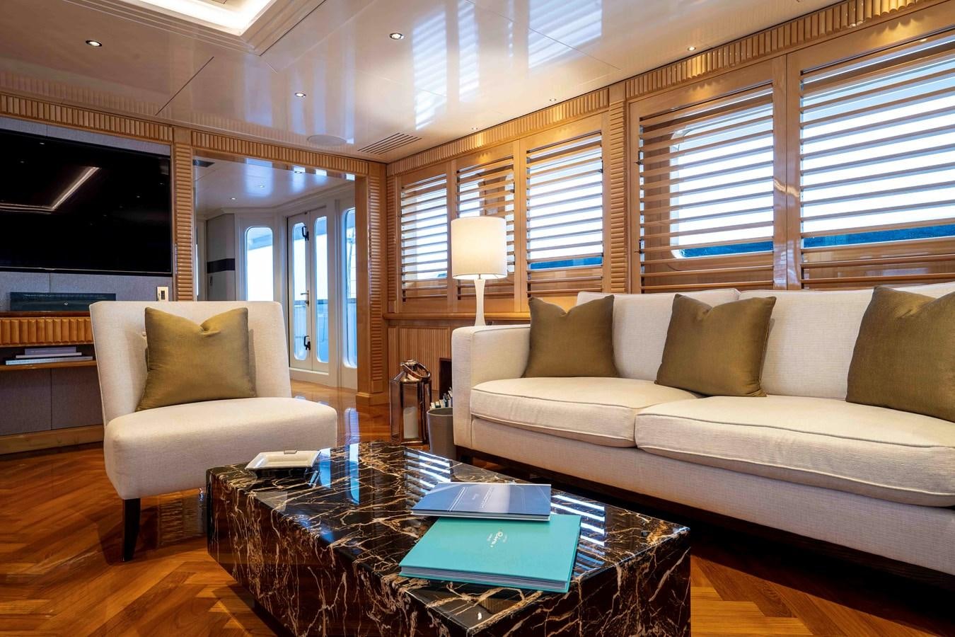 a living room with a couch and a coffee table aboard TACANUYA Yacht for Charter