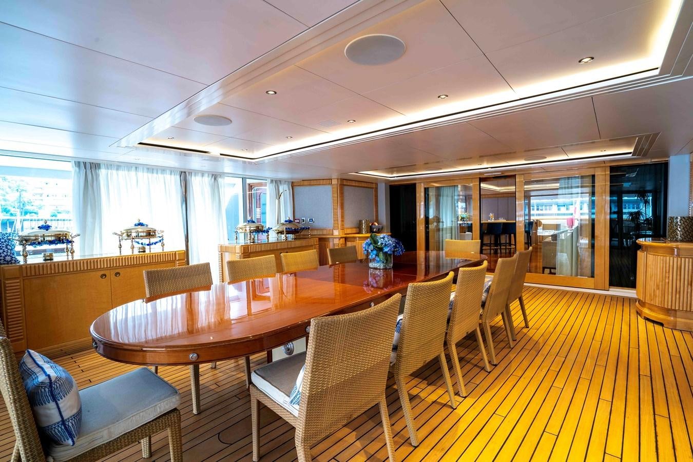 a large room with tables and chairs aboard TACANUYA Yacht for Charter