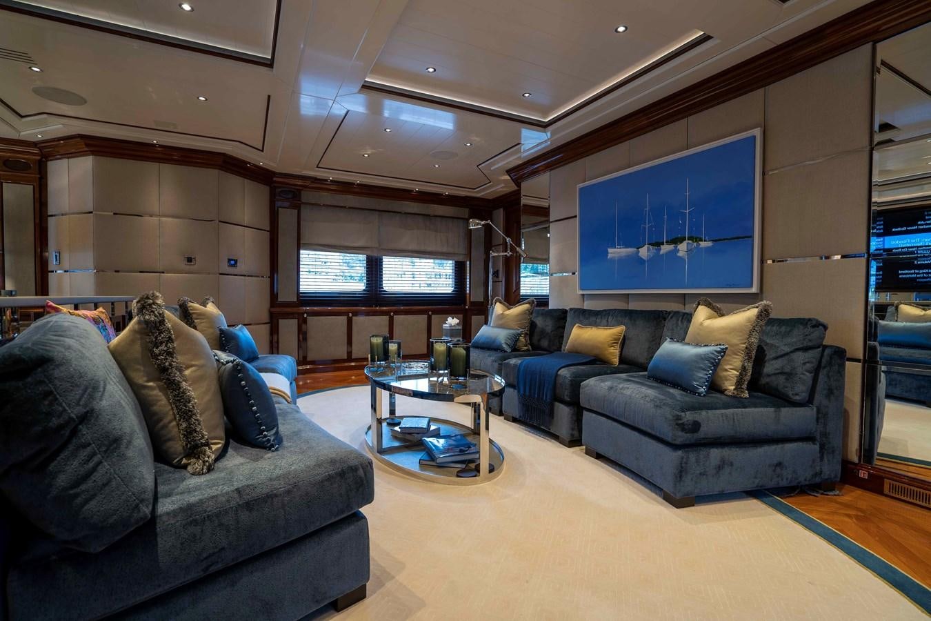a living room with a couch and a tv aboard TACANUYA Yacht for Charter