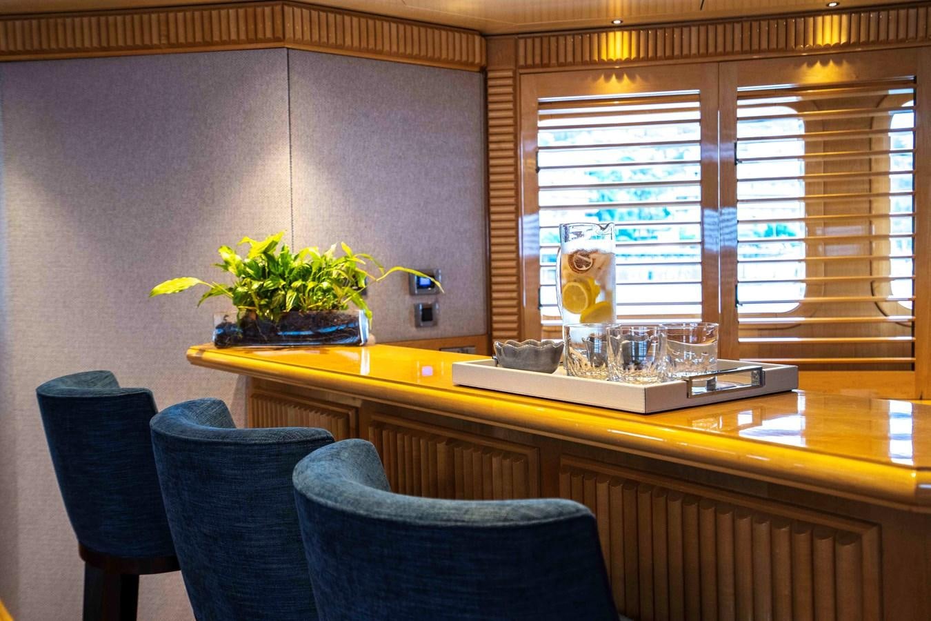 a kitchen with a table and chairs aboard TACANUYA Yacht for Charter