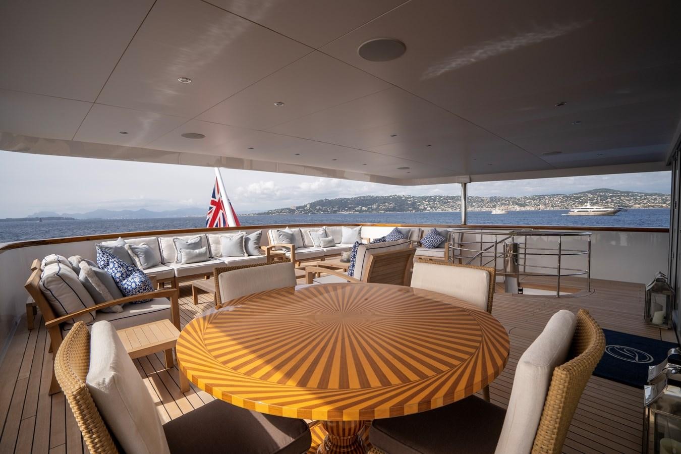 a boat with a table and chairs aboard TACANUYA Yacht for Charter