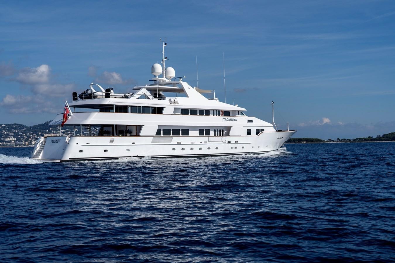 a large white boat in the water aboard TACANUYA Yacht for Sale