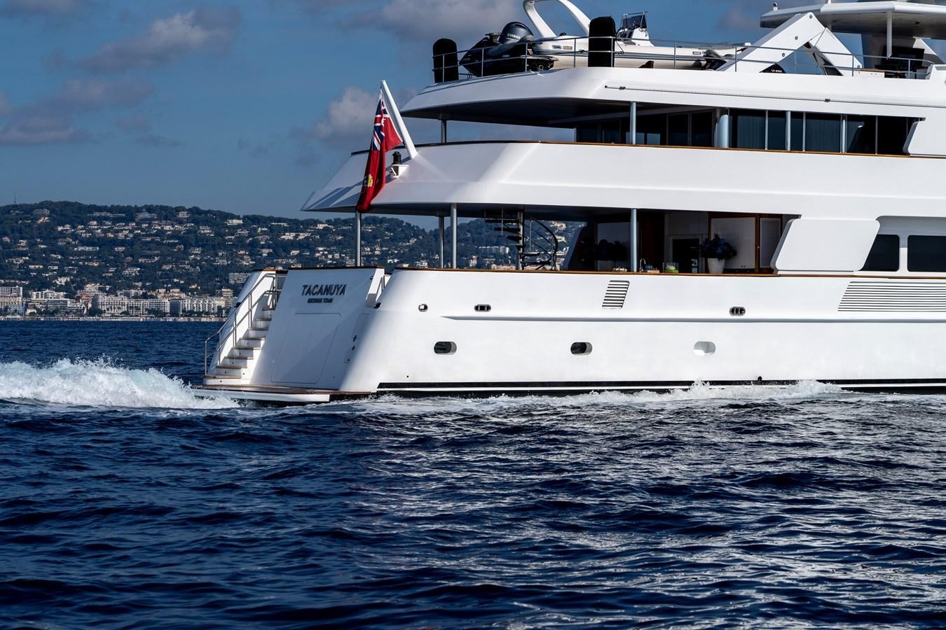 a large white boat on the water aboard TACANUYA Yacht for Sale