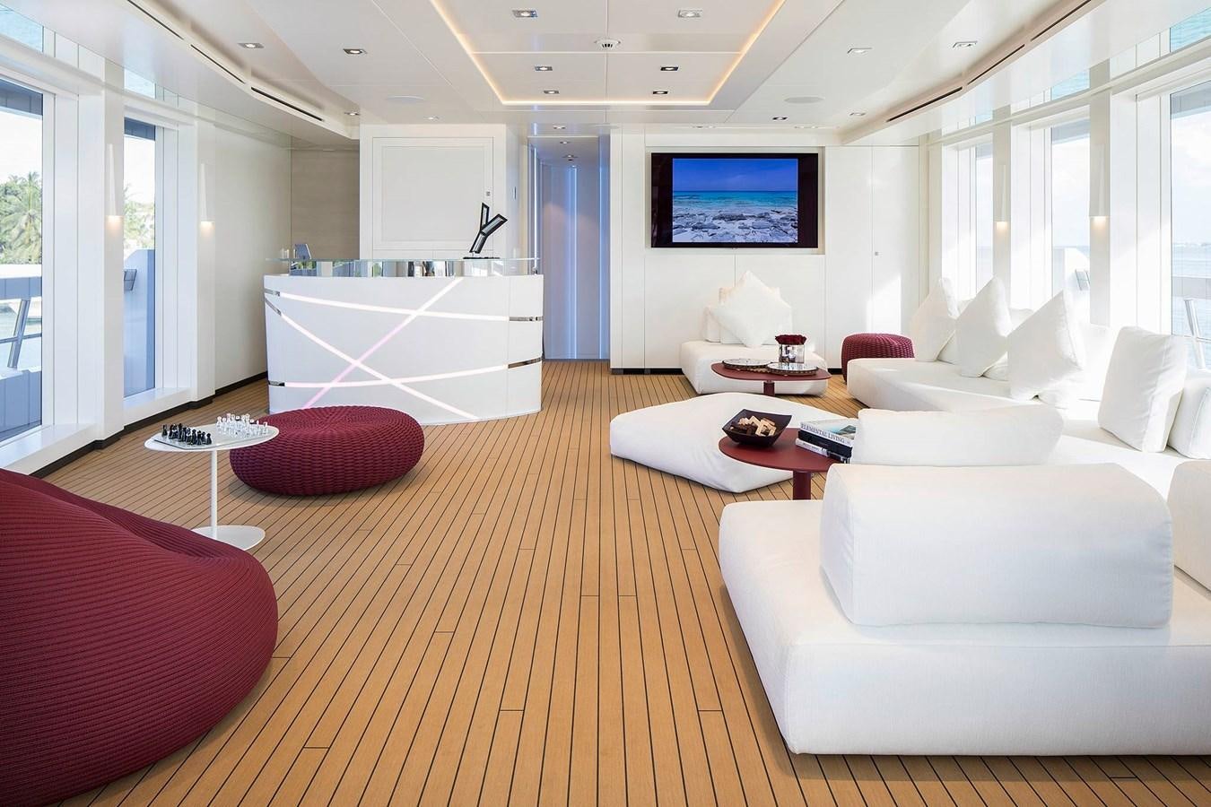 a living room with white couches aboard HOME Yacht for Charter