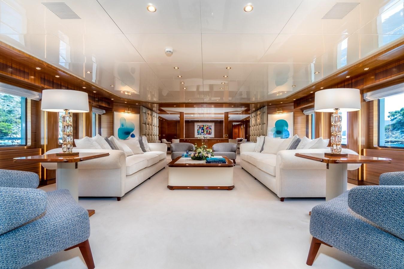 a living room with white furniture aboard OCEANOS Yacht for Sale