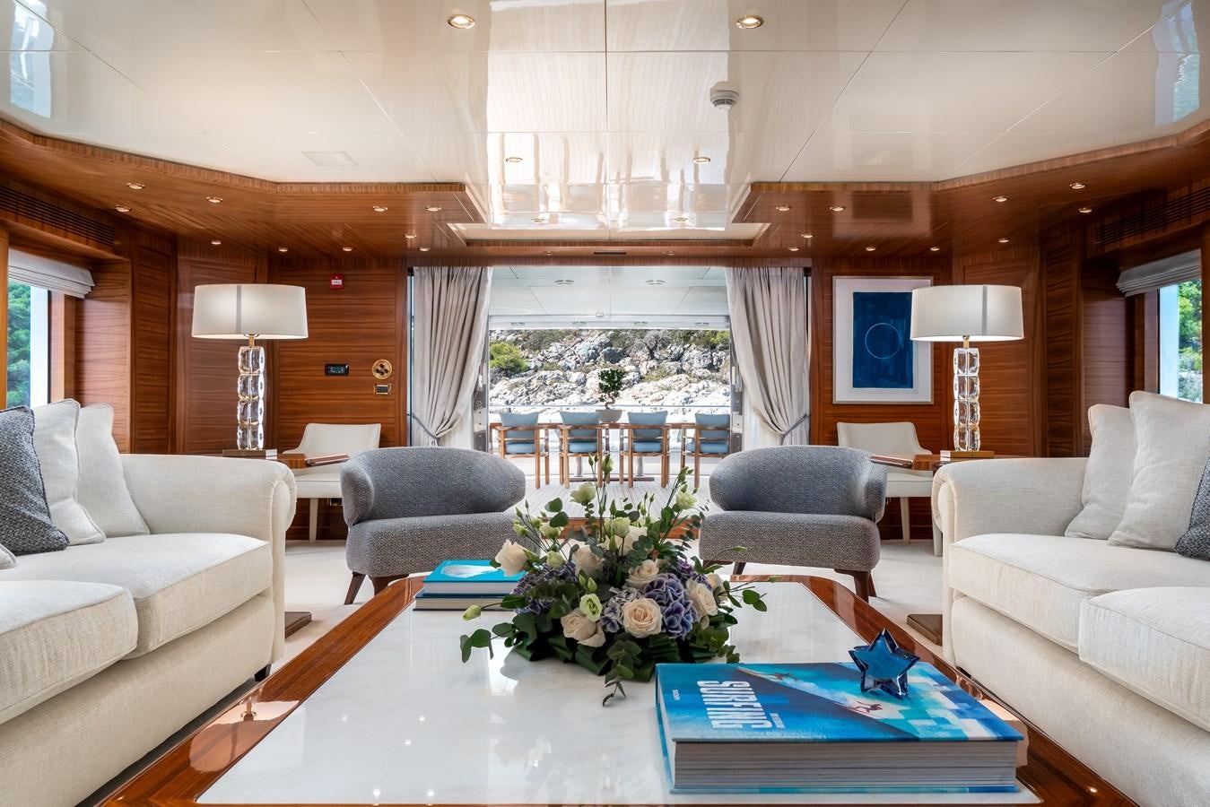a living room with a large window aboard OCEANOS Yacht for Sale