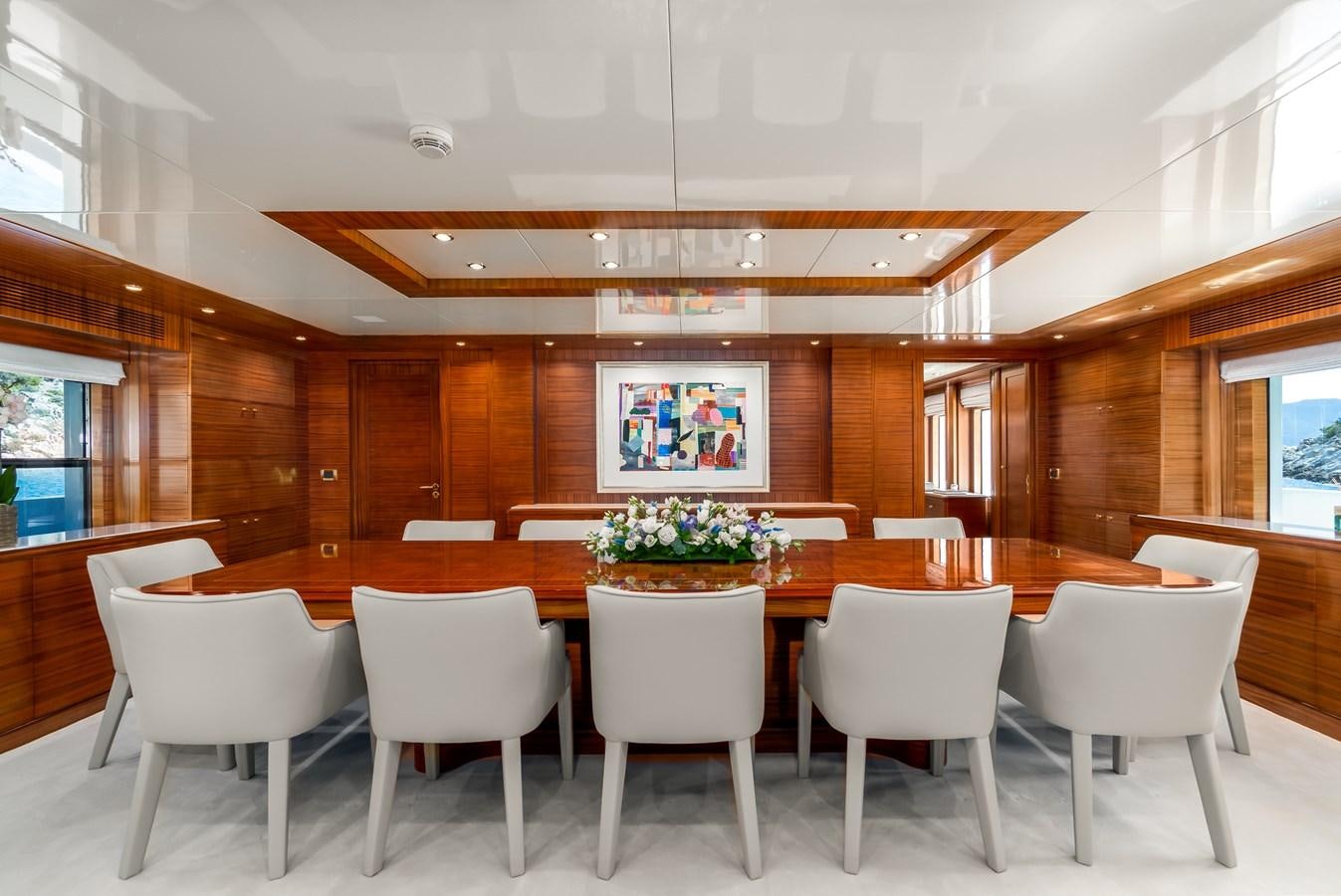 a large room with tables and chairs aboard OCEANOS Yacht for Sale