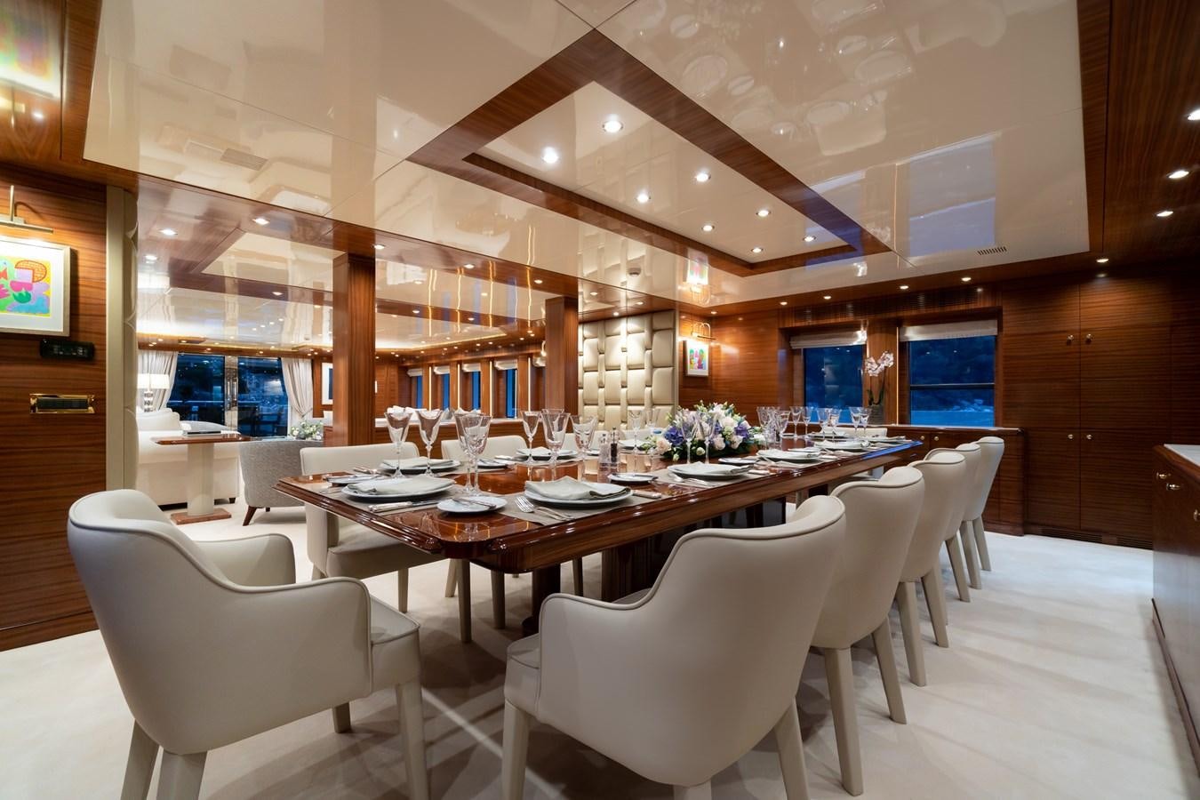 a large dining table in a room aboard OCEANOS Yacht for Sale