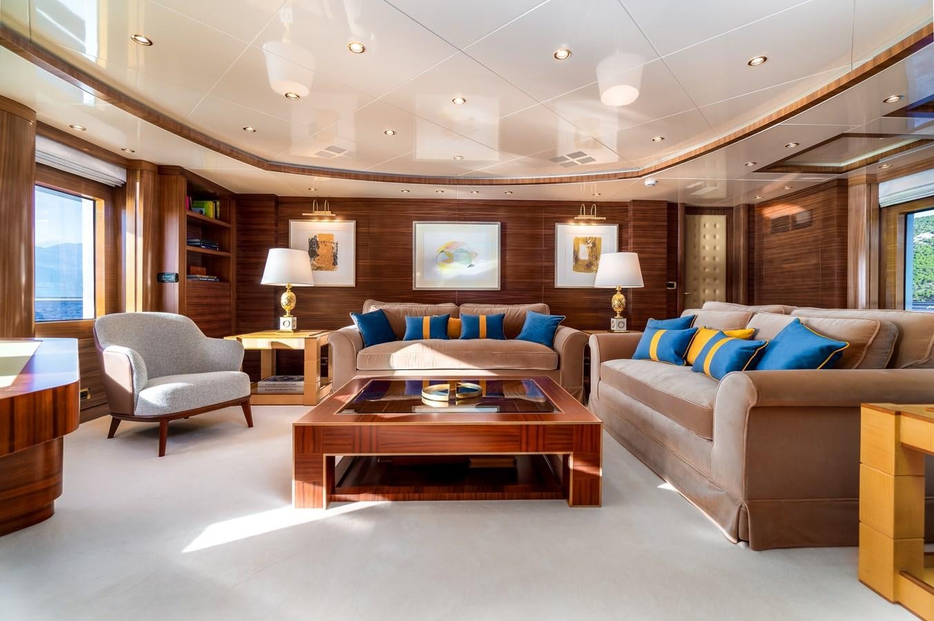 a living room with a couch and a coffee table aboard OCEANOS Yacht for Sale