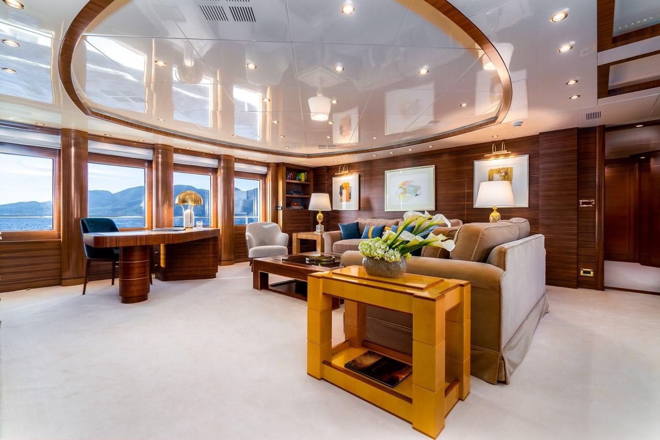 a living room with a couch and a table aboard OCEANOS Yacht for Sale