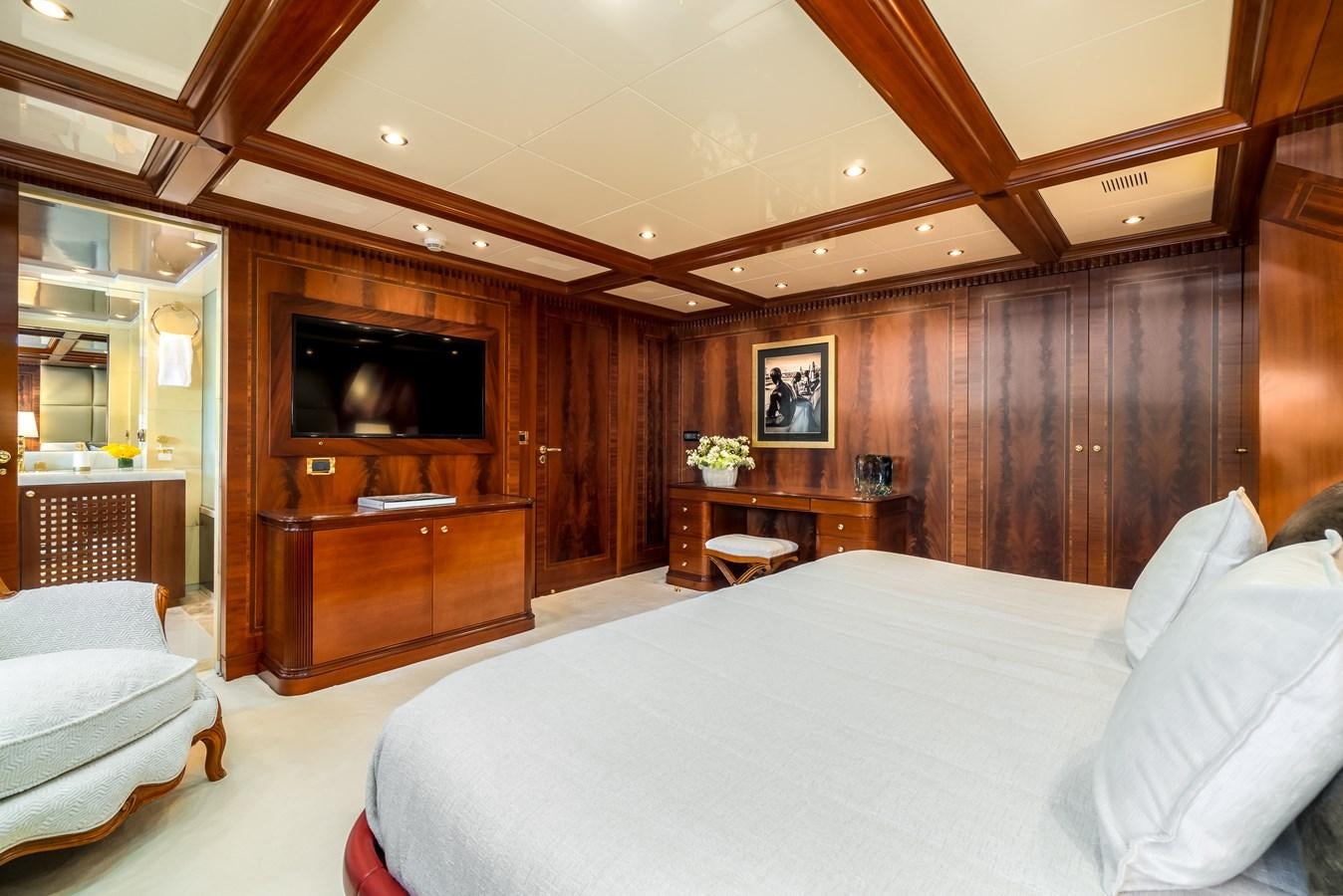 a bedroom with a bed and a television aboard OCEANOS Yacht for Sale