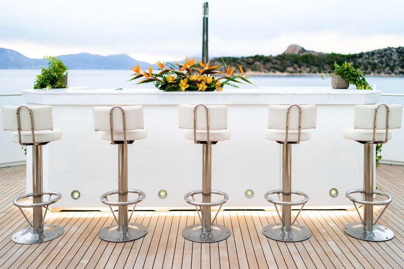 a row of candles on a table aboard OCEANOS Yacht for Sale