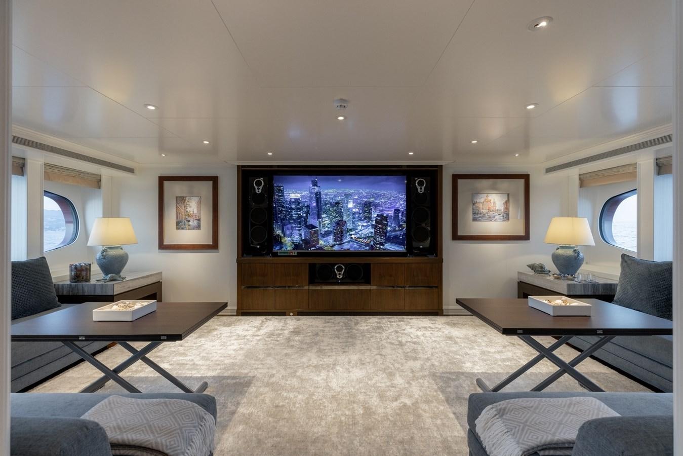 a living room with a large television aboard IDEFIX II Yacht for Charter