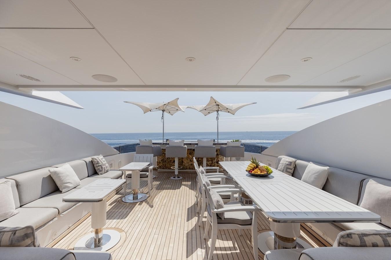 a room with a table and chairs and umbrellas aboard IDEFIX II Yacht for Charter