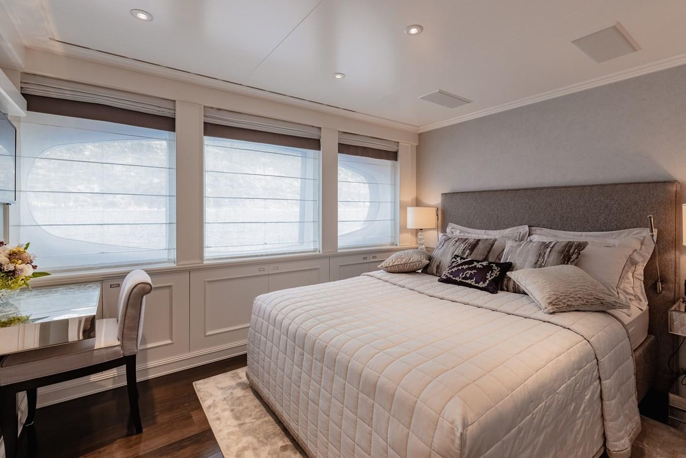 a bedroom with a bed and a table aboard IDEFIX II Yacht for Charter