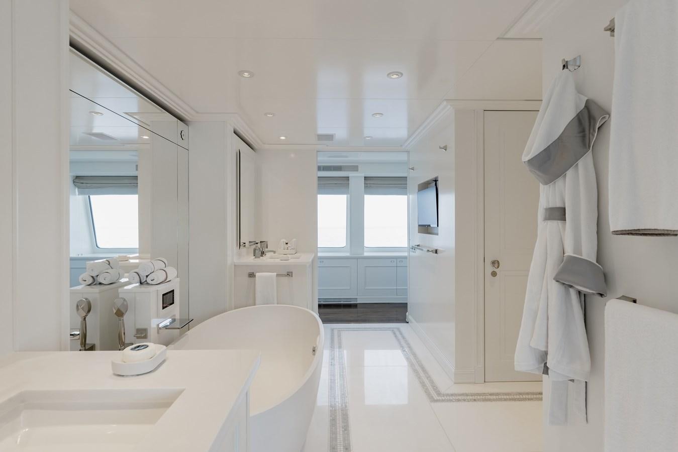 a bathroom with a large bathtub and sinks aboard IDEFIX II Yacht for Charter