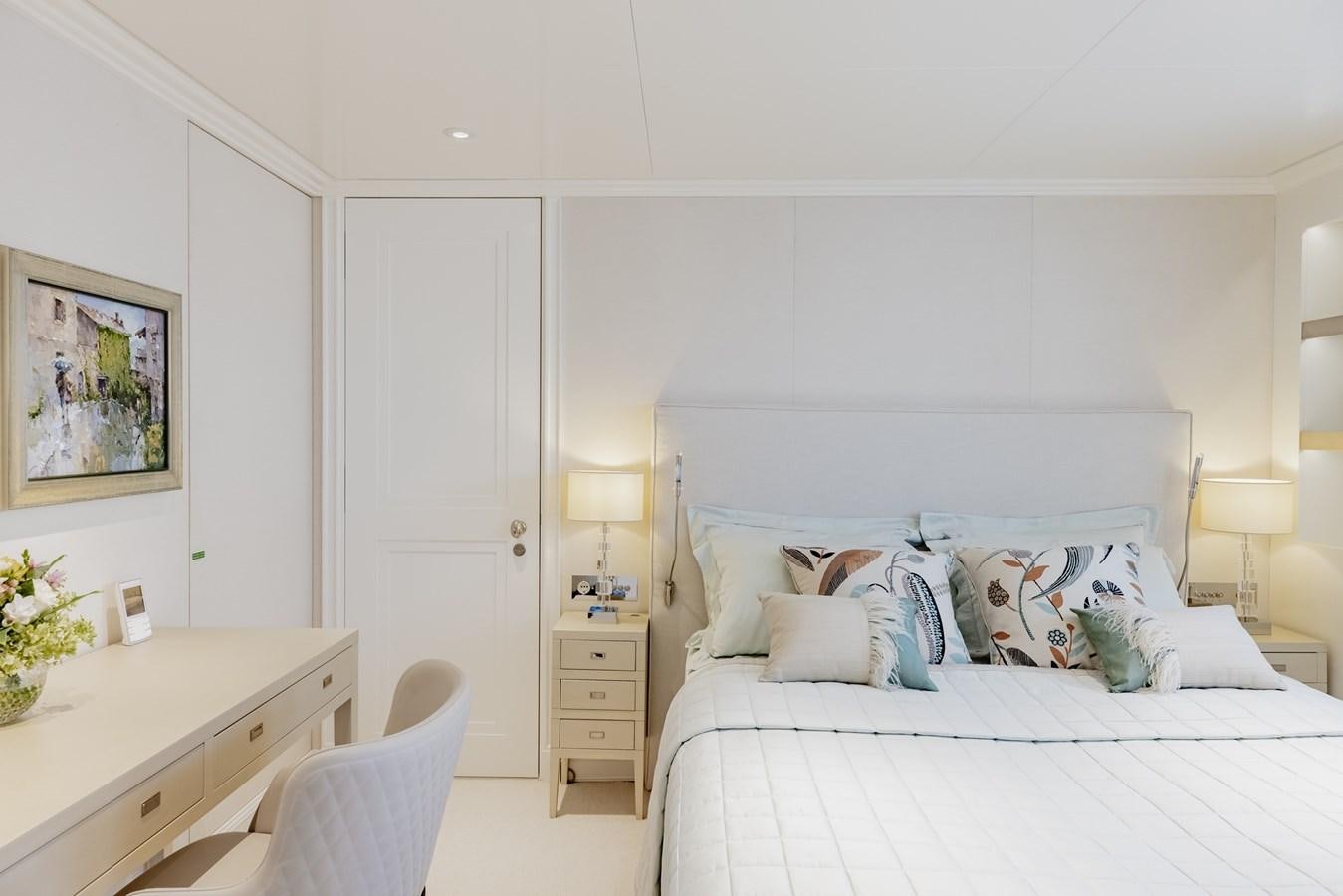 a bedroom with a bed and a desk aboard IDEFIX II Yacht for Charter