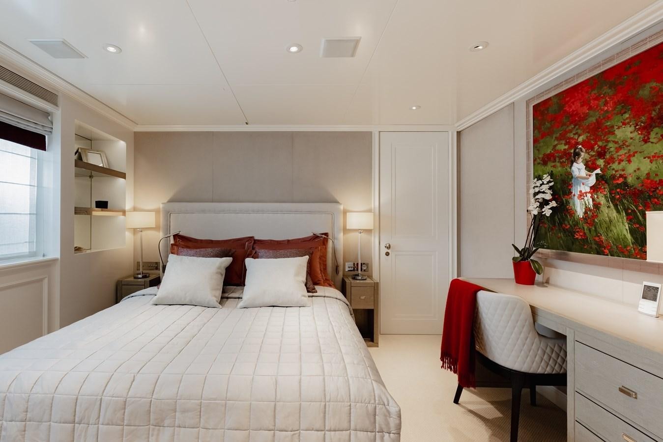 a bedroom with a bed and a desk aboard IDEFIX II Yacht for Charter