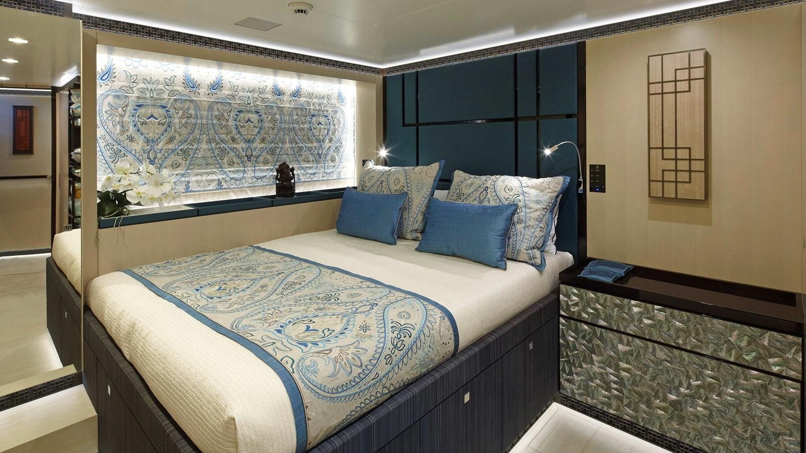 a bed with blue sheets aboard SAGITTA Yacht for Sale