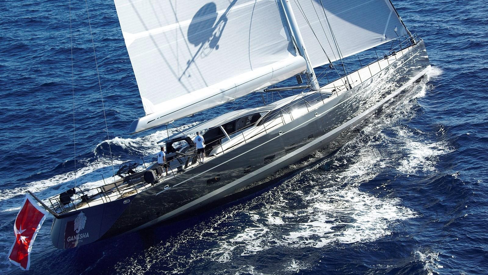 a boat with a flag on it aboard SAGITTA Yacht for Sale