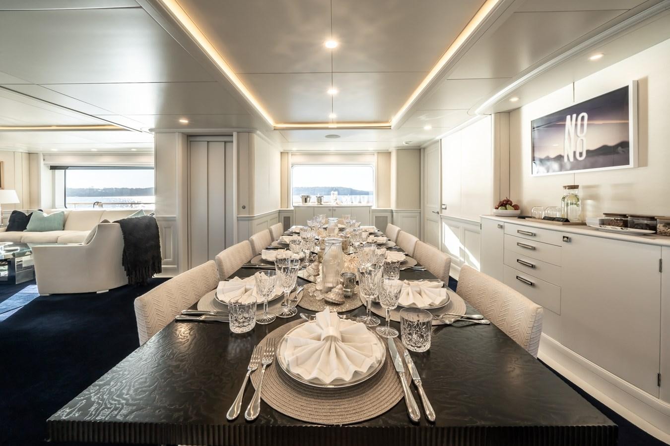 a dining room table with a large white dining table aboard MOATIZE Yacht for Sale