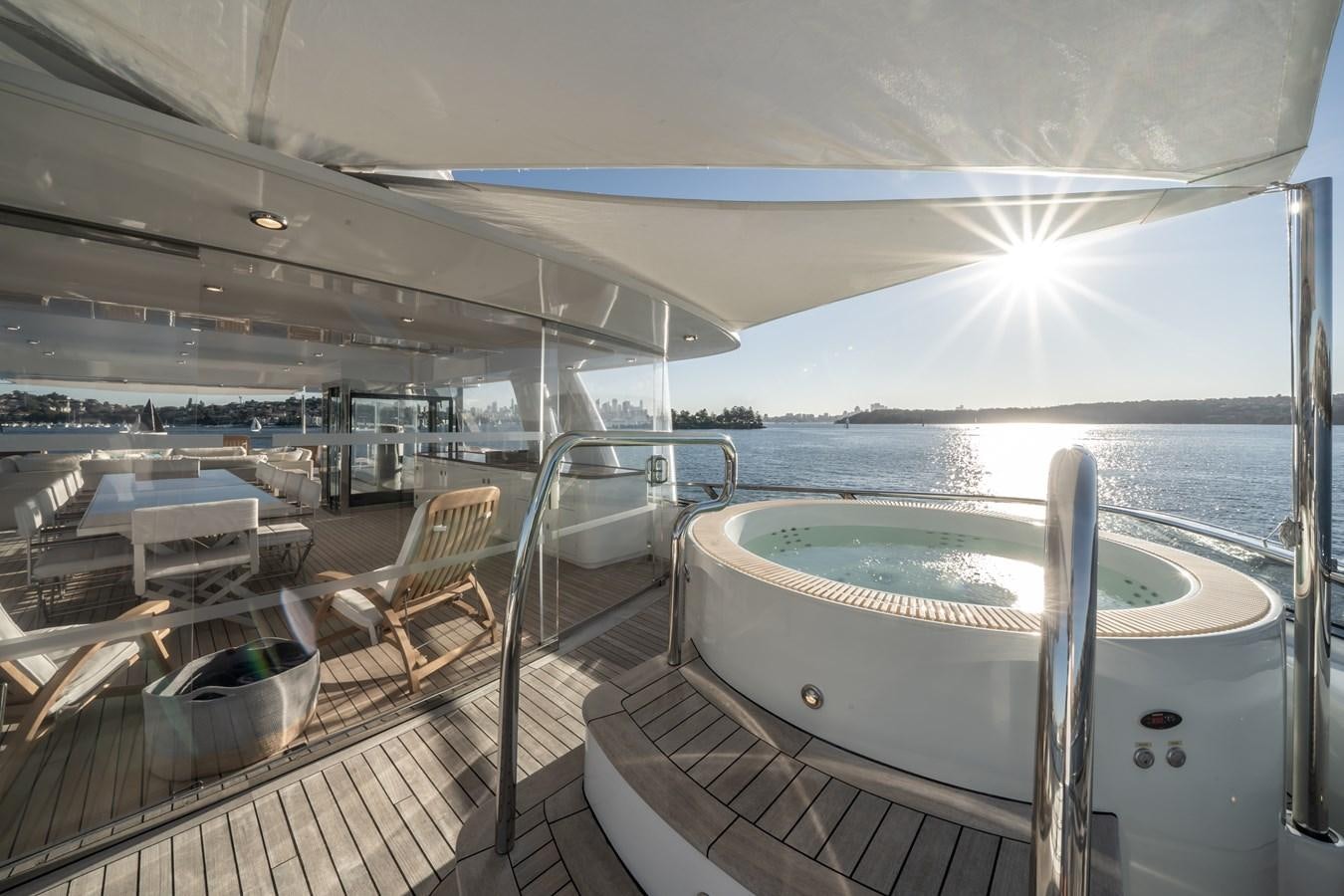 a deck with a pool and chairs aboard MOATIZE Yacht for Sale